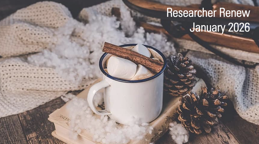 A white mug with a blue rim is filled with hot chocolate, marshmallows and a cinnamon stick. It rests besides pine cones and a notebook next to a large, cream, knitted scarf. The text on the image reads 'Researcher Renew January 2026'.